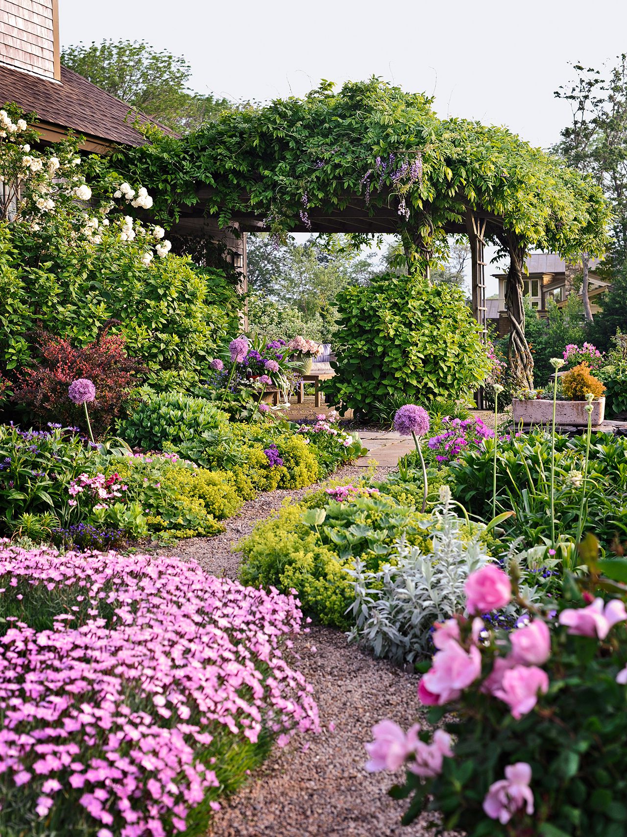 Colorful garden beds with zone-3 hardy perennials in an Edmonton yard