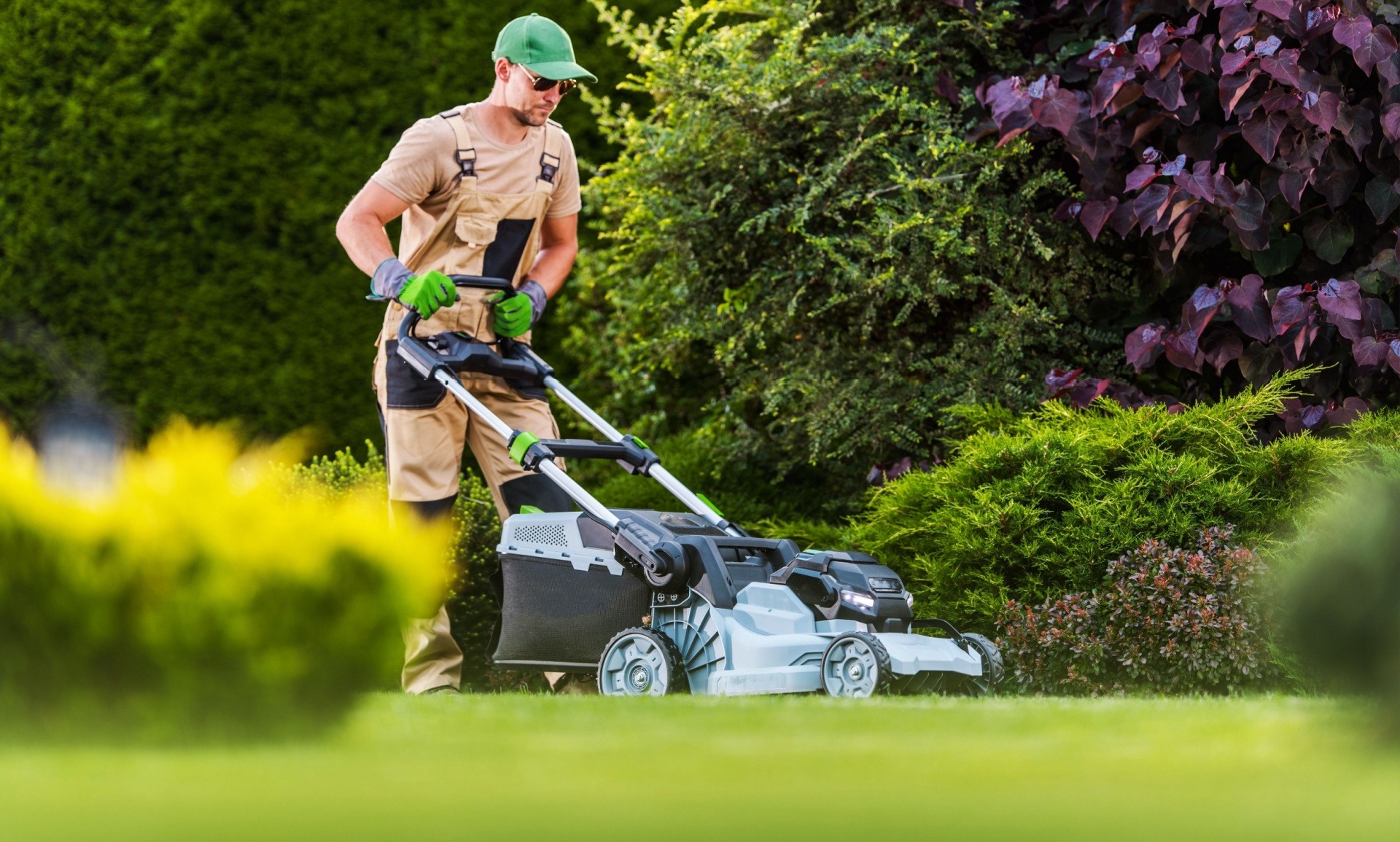 Lawn care professional mowing an Edmonton residential lawn